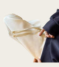 Person holding a piece of beige woven fabric