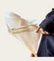 Person holding a piece of beige woven fabric