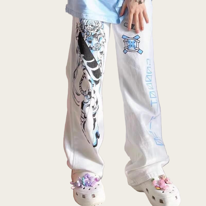 Person wearing white pants with colorful designs, standing next to a plush toy on a light-colored floor.