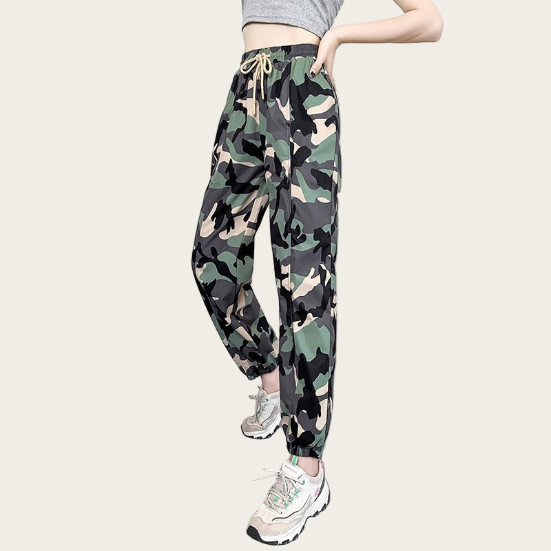 Camouflage pants worn by a person on a yellow background