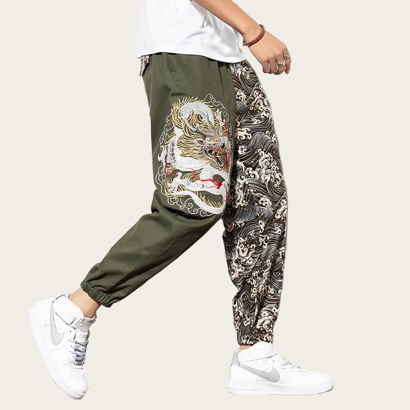 Person wearing green pants with a dragon design and white sneakers