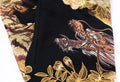 Embroidered dragon design on a black fabric with gold and brown details