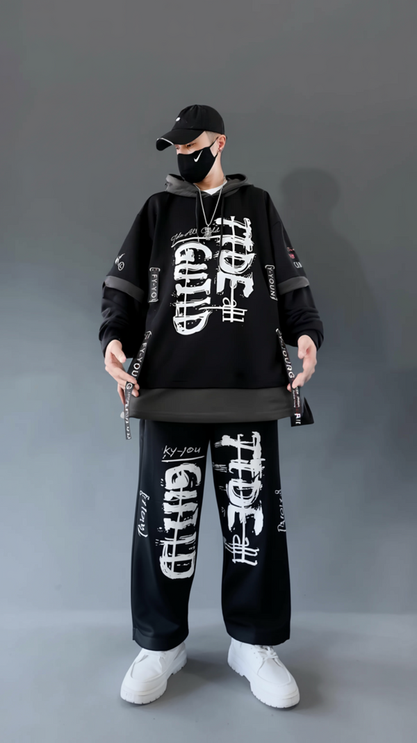Person wearing a black outfit with white text on a gray background