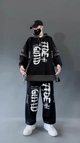 Person wearing a black outfit with white text on a gray background