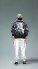 Person wearing a black jacket with white designs on a gray background