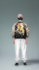 Person wearing a stylish jacket with floral design on a plain background