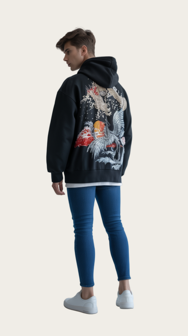 Person wearing a black hoodie with a colorful design on the back, standing against a plain background.