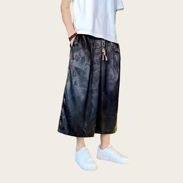 Person wearing black patterned pants and white sneakers