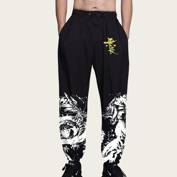 Black jogger pants with white tiger design and yellow logo on a yellow background