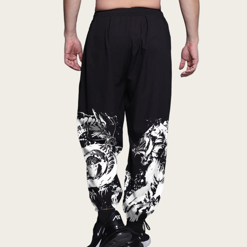 Black pants with white graphic designs on a plain background