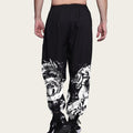 Black pants with white graphic designs on a plain background