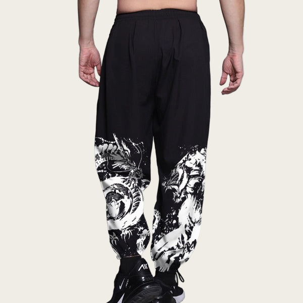 Black pants with white graphic designs on a plain background