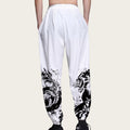 White pants with black abstract designs on a plain background