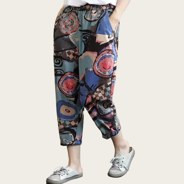 Colorful patterned pants worn by a person on a plain background