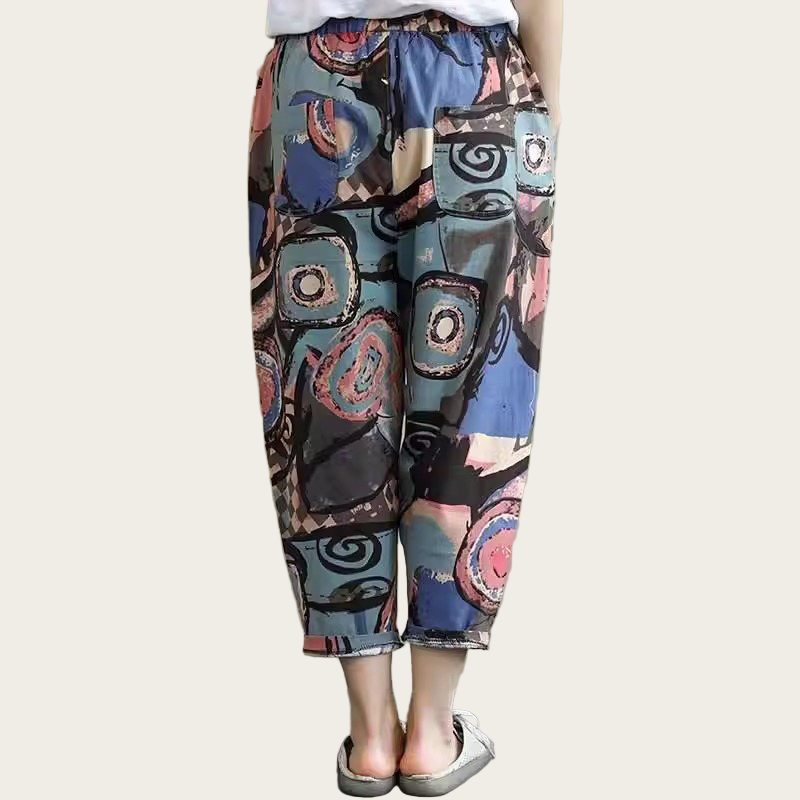 Colorful patterned pants worn by a person on a plain background