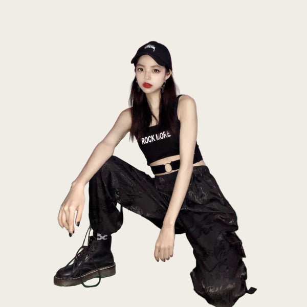 Person wearing a black tank top with 'ROCK MORE' text, black pants, and black shoes.