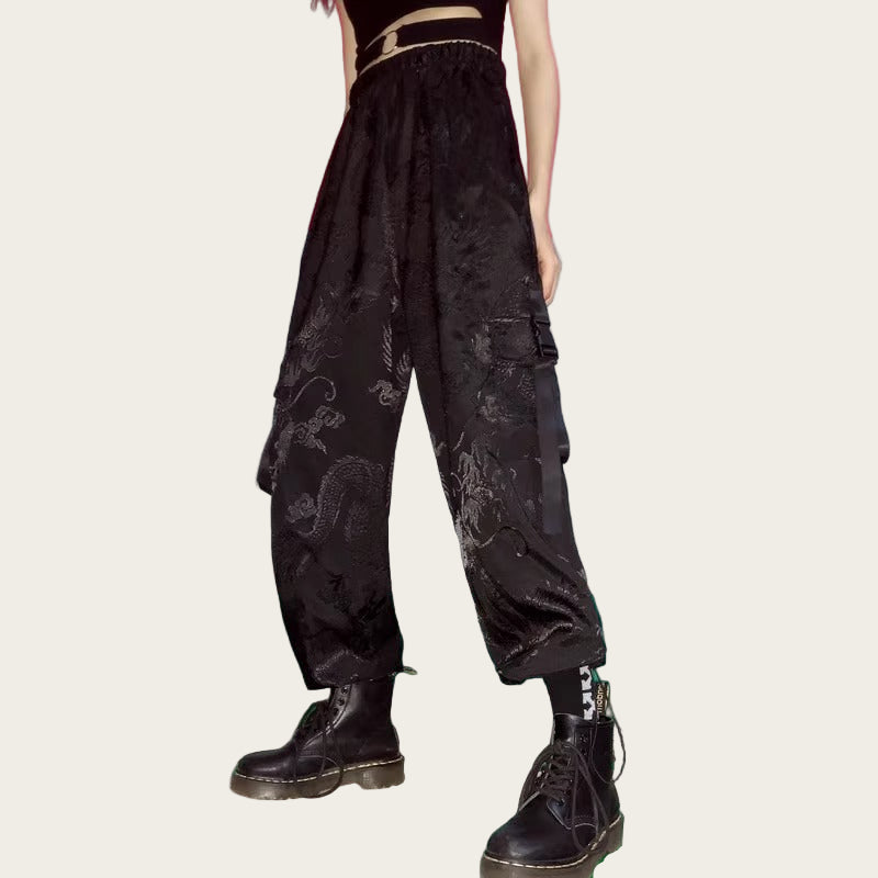 Person wearing black floral-patterned cargo pants.
