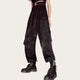Person wearing black floral-patterned cargo pants.