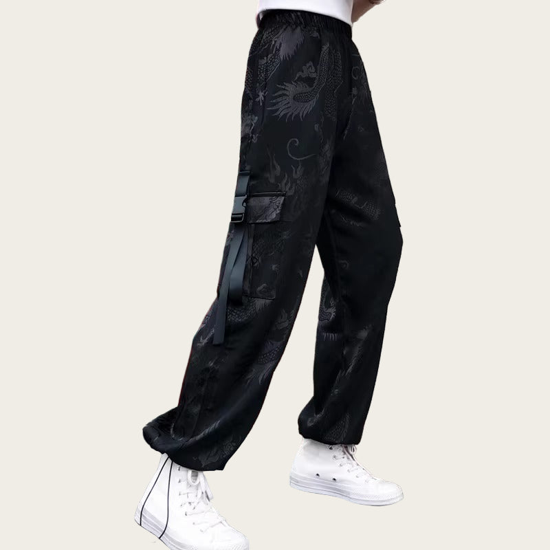 Person wearing black pants with white sneakers in front of a Coca-Cola machine.