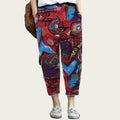 Colorful patterned pants worn by a person against a plain background