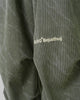 Close-up of the embroidered BJHG Bejusthug logo on the olive green pants