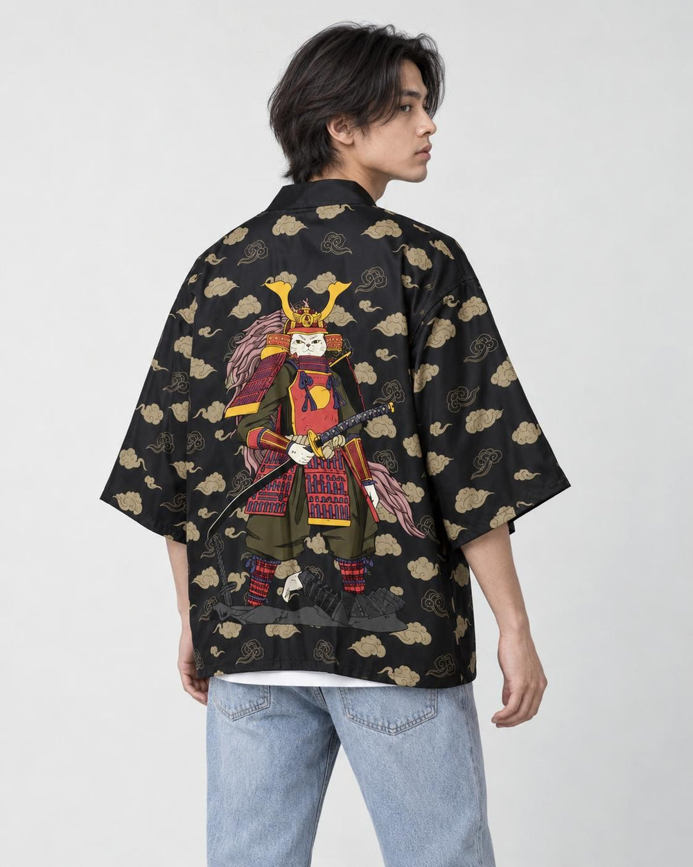 Man in the black haori seen from behind at an angle, with tan clouds and an armored cat on the back, over a white tee