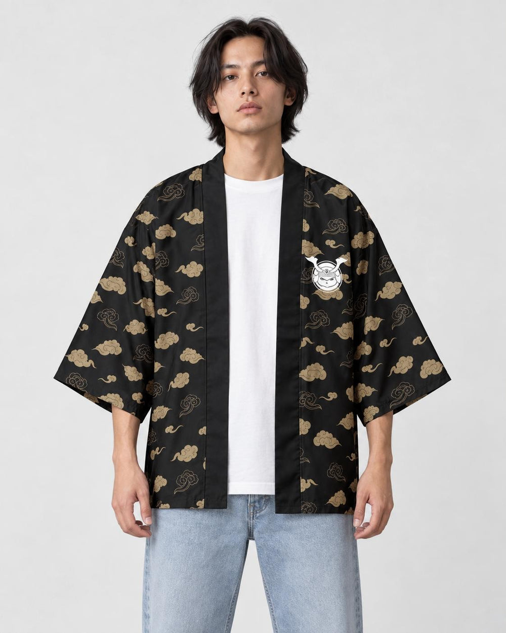 Man in the open black cloud-pattern haori with a small white cat emblem on the chest, a white tee and light jeans