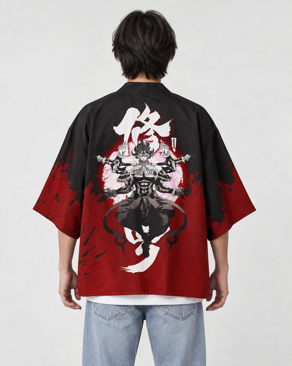 Man seen from behind in the black and red haori with a white character and a many-armed asura on the back