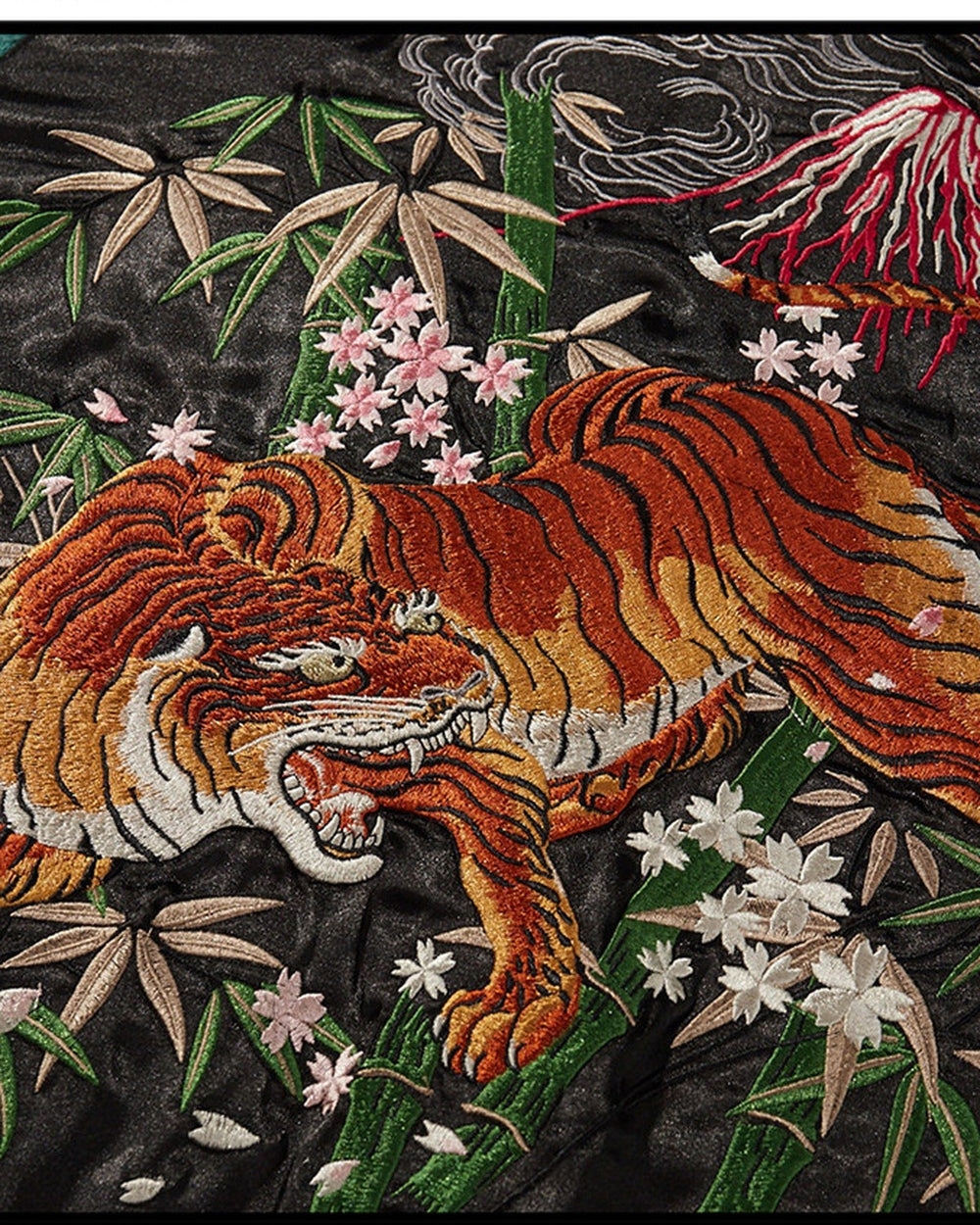 Close-up of the tiger among bamboo and pink blossoms under Mount Fuji
