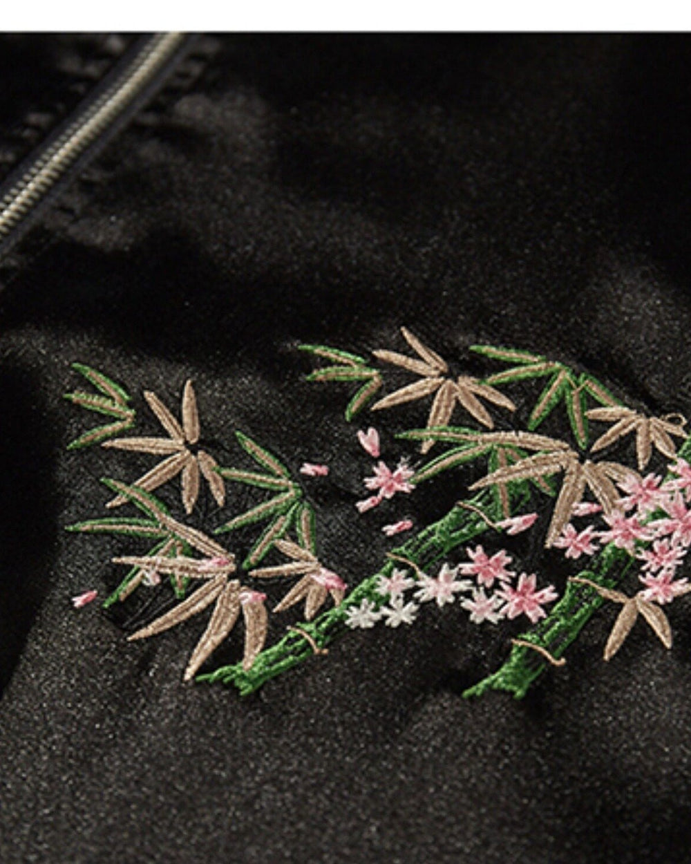 Close-up of the embroidered bamboo and blossom sprig on the chest