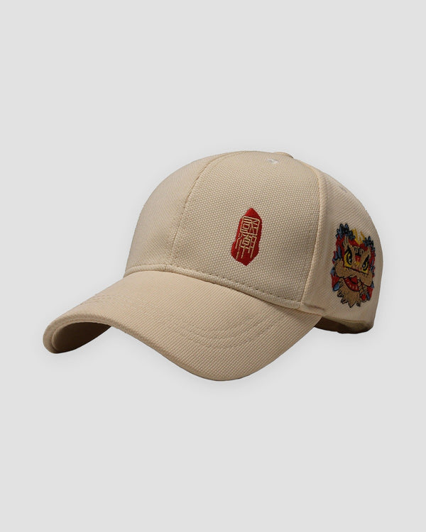 Beige baseball cap with a small red seal stamp on the front and a lion-dance head on the side