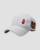 White baseball cap with a small red seal stamp on the front and a lion-dance head on the side