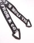 Close-up of the blackletter ribbon tails ending in black triangle loops