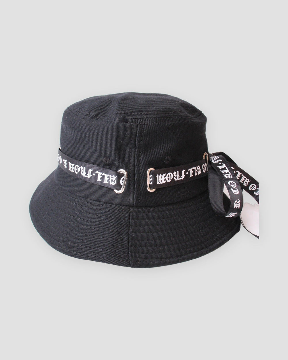 Black bucket hat with a white blackletter ribbon through silver rings, three-quarter view