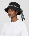 Model wearing the black ribbon bucket hat, side view