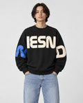 Model wearing the black block letter print sweatshirt, front view