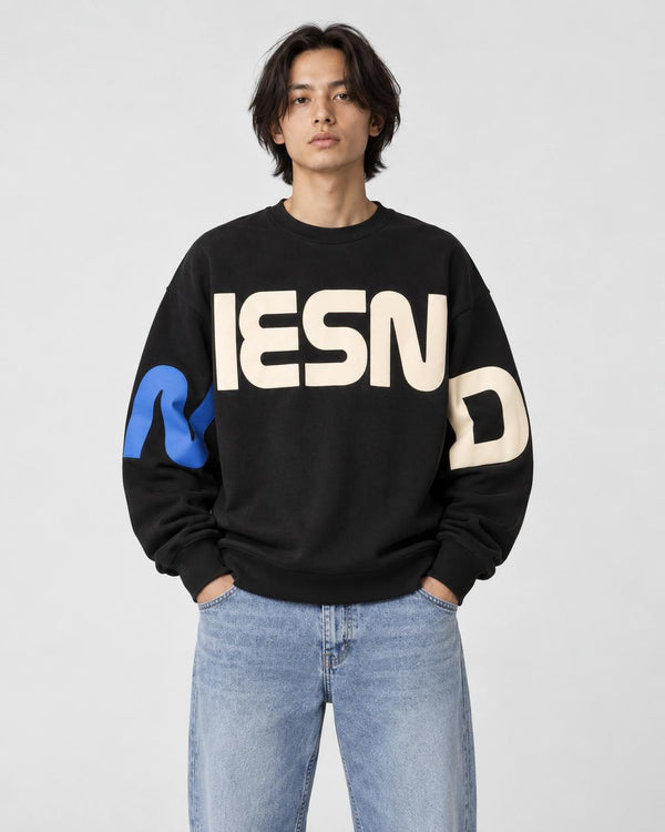 Model wearing the black block letter print sweatshirt, front view