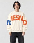 Model wearing the cream sweatshirt with orange block letters, front view