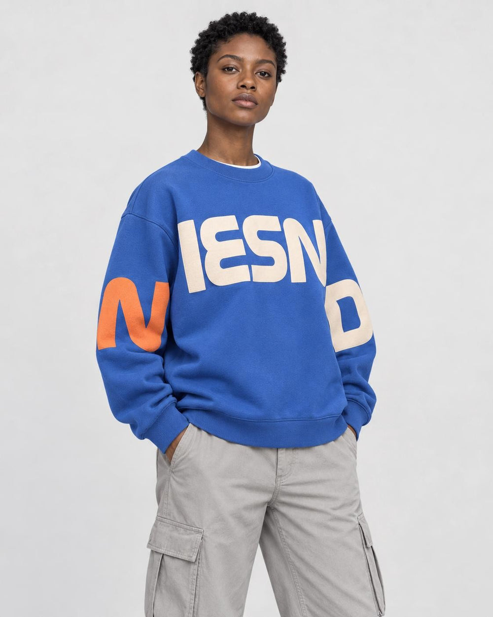 Model wearing the blue block letter print sweatshirt, three-quarter view