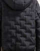 Back of the black jacket showing the brick-pattern quilting and the hood