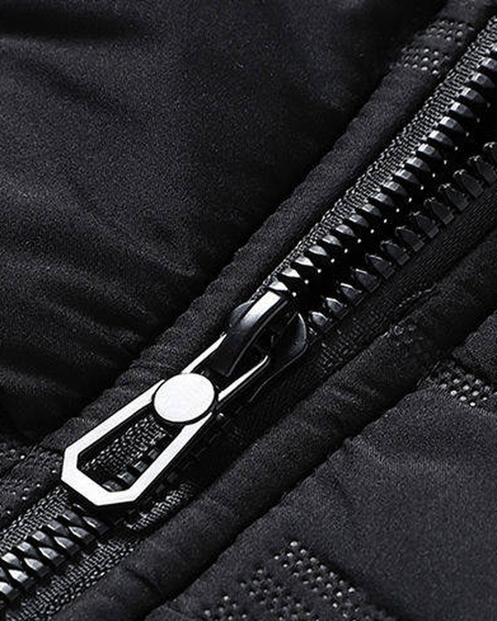 Close-up of the metal zip pull and the quilted fabric on the black jacket