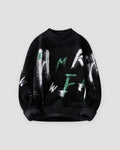 Black fuzzy knit sweater printed with white and green brushstroke letters