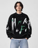 Model wearing the black brushstroke letter sweater with jeans, front view