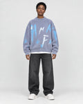 Model wearing the blue gray fuzzy knit sweater, front view