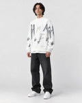Model wearing the white brushstroke letter sweater, three-quarter view