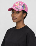 Model wearing the pink butterfly embroidered cap, three-quarter view