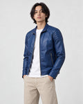 Model wearing the royal blue ridged shoulder jacket, three-quarter view
