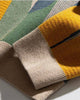 Close-up of the knitted cat pattern at the cuff