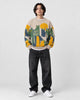 Model wearing the beige cat and moon sweater with jeans, front view