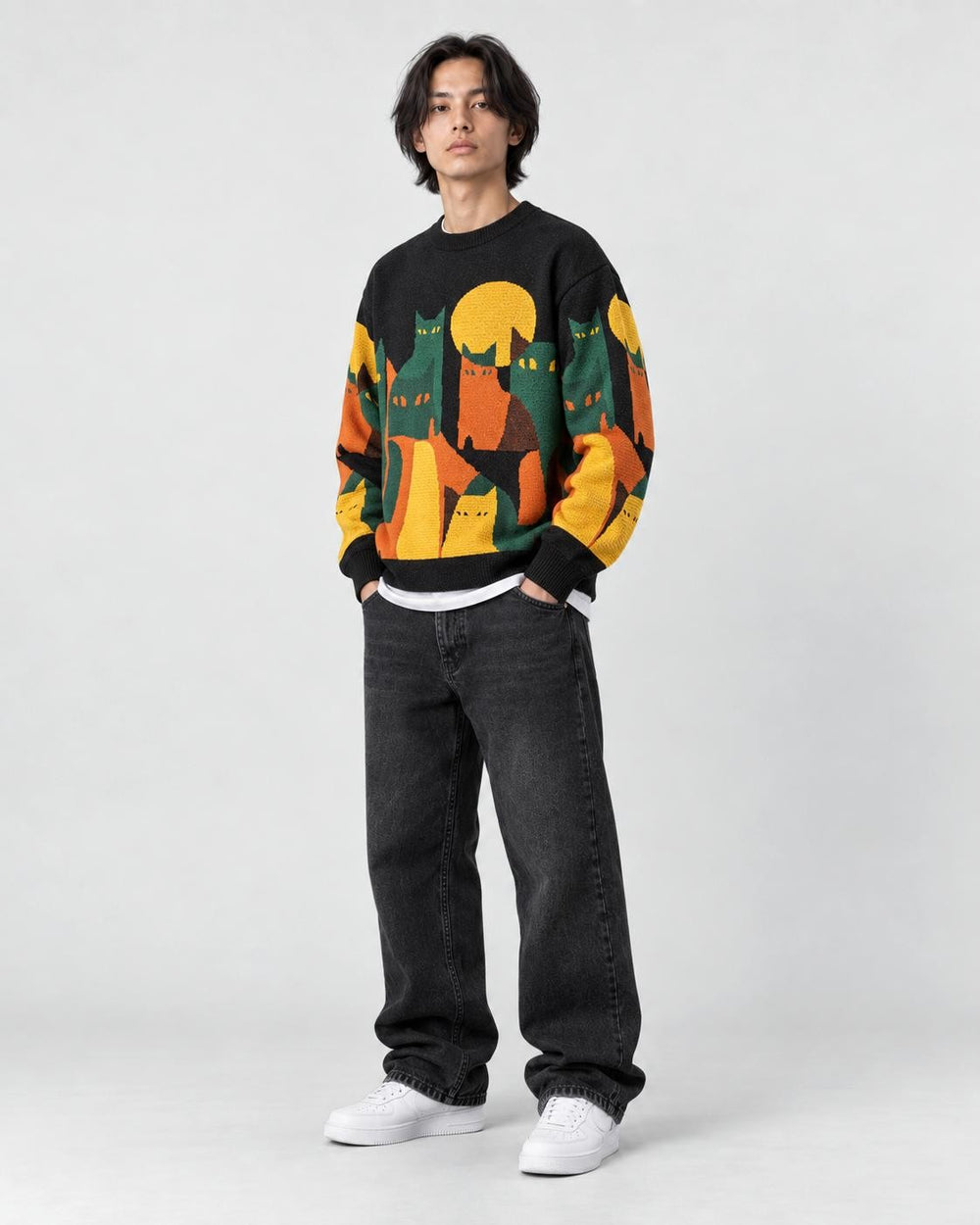 Model wearing the black cat and moon sweater, three-quarter view